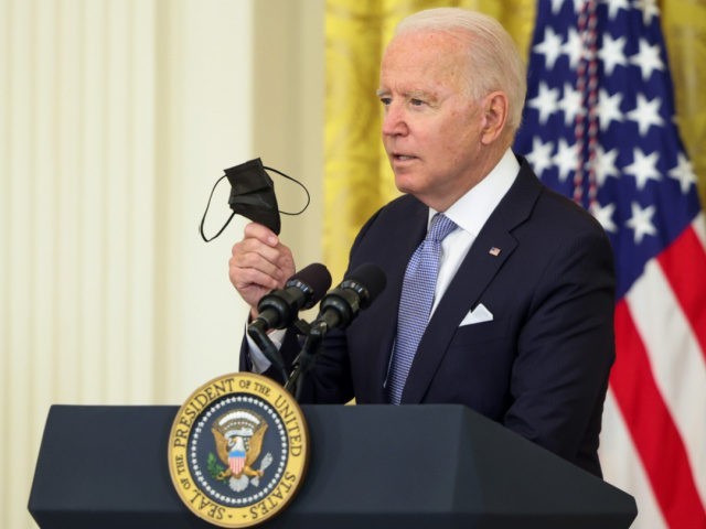WASHINGTON, DC - JULY 29: U.S. President Joe Biden holds up a face mask as he delivers remarks in the East Room of the White House on July 29, 2021 in Washington, DC. President Biden spoke on his administration's effort to get more Americans vaccinated and plan to combat the …