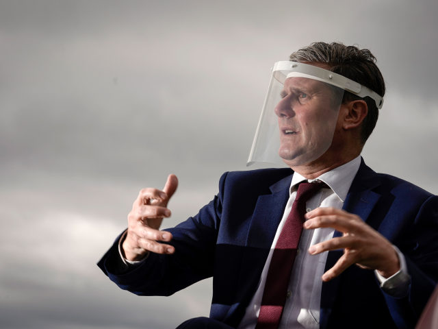 NOTTINGHAM, ENGLAND - JULY 16: Labour Party leader, Sir Keir Starmer, wears a face visor during talks with care home workers and family members of residents during a visit to Cafe 1899 in Gedling Country Park on July 16, 2020 in Nottingham, England. The opposition leader discussed the impact of …