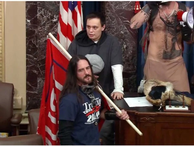 Paul Allard Hodgkins carries a large red "Trump 2020" flag inside the Senate chamber during the Capitol riot on Jan. 6.FBI