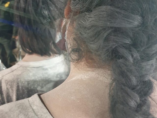 A migrant woman is covered in a dangerous scent-masking chemical by human smugglers. (Phot
