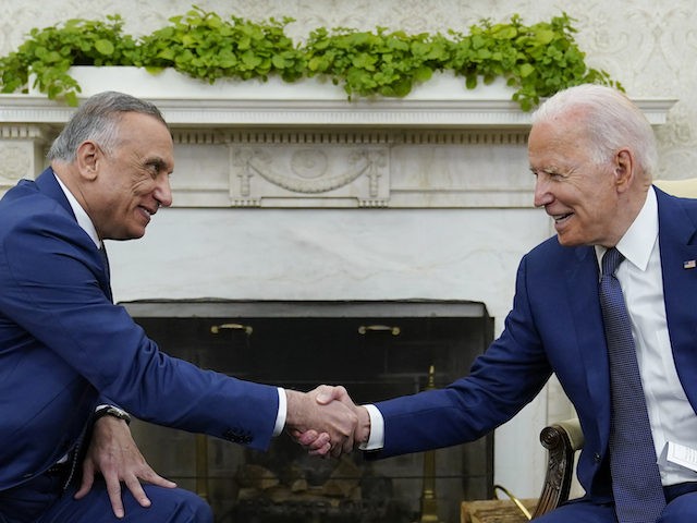 President Joe Biden, right, shakes hands with Iraqi Prime Minister Mustafa al-Kadhimi, lef