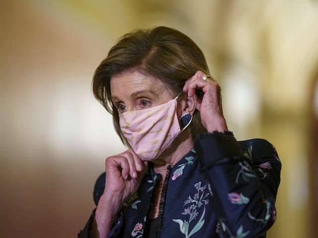 Speaker of the House Nancy Pelosi, D-Calif., dons her face mask as she hosts a visit by Ki