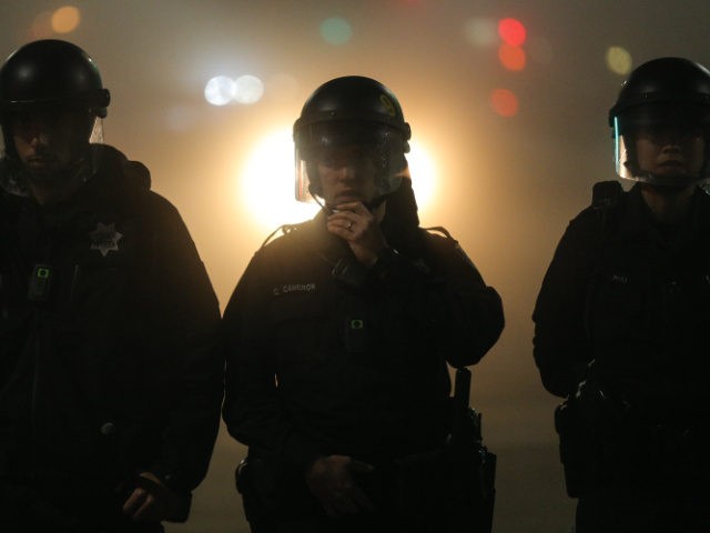 OAKLAND, CA - DECEMBER 4: Police officers wearing body cameras form a line in East Oakland on the second night of demonstrations following a Staten Island, New York grand jury's decision not to indict a police officer in the chokehold death of Eric Garner on December 4, 2014 in Oakland, …