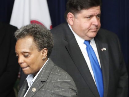 Illinois Gov. J.B. Pritzker, right, and Chicago mayor Lori Lightfoot participate in a news conference where the governor announced a shelter in place order to combat the spread of the COVID-19 virus, Friday, March 20, 2020, in Chicago. (AP Photo/Charles Rex Arbogast)