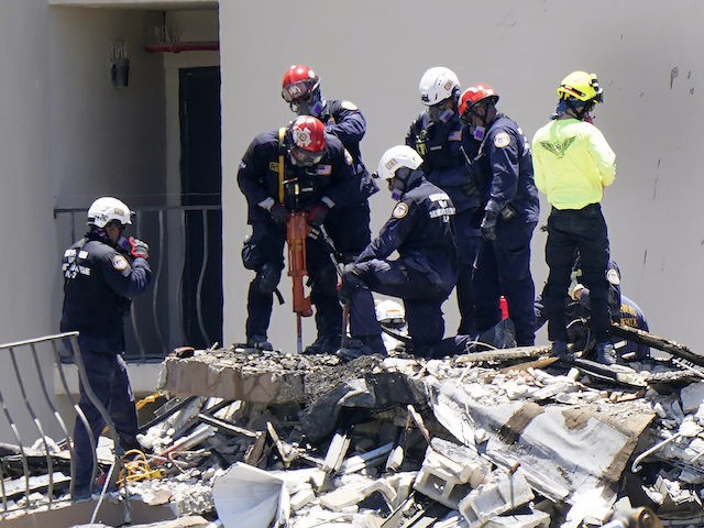 Crews work in the rubble at the Champlain Towers South Condo, Sunday, June 27, 2021, in Surfside, Fla. One hundred fifty-nine people were still unaccounted for two days after Thursday's collapse. (AP Photo/Wilfredo Lee)