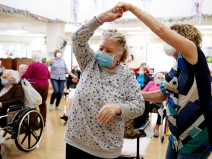 Residents and staff gather and dance during an Easter concert for vaccinated residents at the Ararat Nursing Facility in the Mission Hills neighborhood on April 1, 2021 in Los Angeles, California. The concert was the first social event held at the facility since the beginning of the pandemic amid newly …