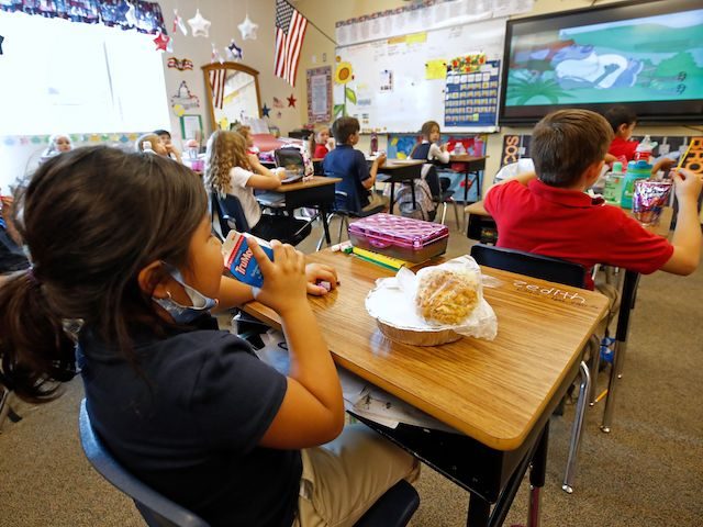 A student eats lunch in her classroom at Freedom Preparatory Academy on September 10, 2020 in Provo, Utah. - In person schooling with masks has started up in many Utah schools since shutting down in March of this year due to the covid-19 virus. (Photo by GEORGE FREY / AFP) …