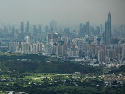 HONG KONG - JULY 11: A general view of North East New Territories in front of the Shenzhen skyline taken from Ping Che village on July 11, 2013 in Hong Kong, China. The North East New Territories New Development Areas project proposed by HKSAR Government to redevelop land under active …