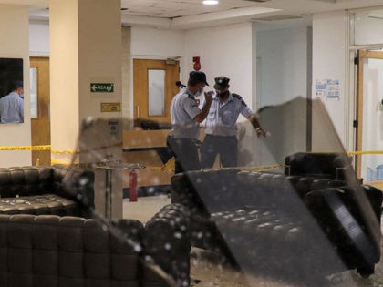 Members of the Cyprus national police inspect the headquarters of local broadcaster Sigma TV in the capital Nicosia on July 18, 2021 after protesters against coronavirus measures attacked the premises late in the evening. - Police confirmed the incident at Sigma TV and said around 2,500 protesters went to the …