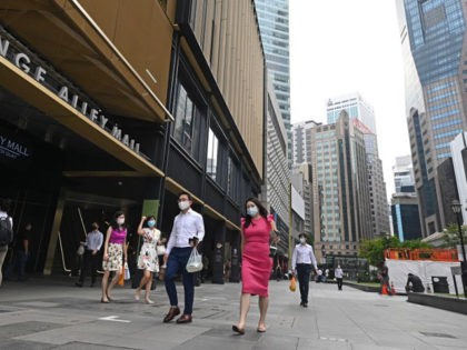 People walk during lunch time at the Raffles Place financial business district in Singapor