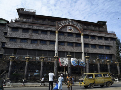 A minibus drives by as church members gather at the main gate of The Synagogue Church of A