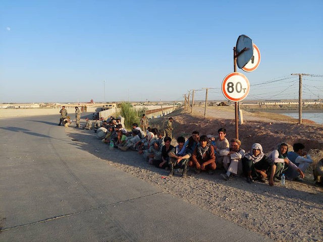 In this handout photo released by Border Troops of the State Committee for National Security of the Republic of Tajikistan on Tuesday, June 22, 2021, Afghanistan’s government soldiers sit at a bridge next to Tajikistan-Afghanistan border in Tajikistan. 134 servicemen of the government forces of Afghanistan were forced to retreat …