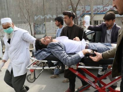 An injured man is brought on a stretcher to an ambulance following a gun attack during an event to mark the 25th anniversary of death of Shiite leader Abdul Ali Mazari, In Kabul on March 6, 2020. - At least 27 people were killed in an attack on a political …