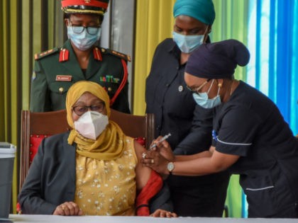 Tanzania's President Samia Suluhu Hassan (L) receives a shot of the Johnson & Johnson vaccine from a health worker at the State House in Dar es Salaam, on July 28, 2021, during a mass vaccination campaign against the Covid-19. - Tanzania kicked off its Covid-19 vaccination drive on July 28, …