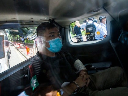 HONG KONG, CHINA - JULY 06: Hong Kong defendant Tong Ying-Kit, 23, arrives at court after being accused of deliberately driving his motorcycle into a group of police officers last Wednesday on July 6, 2020 in Hong Kong, China. Tong is the first person to be charged for incitement to …