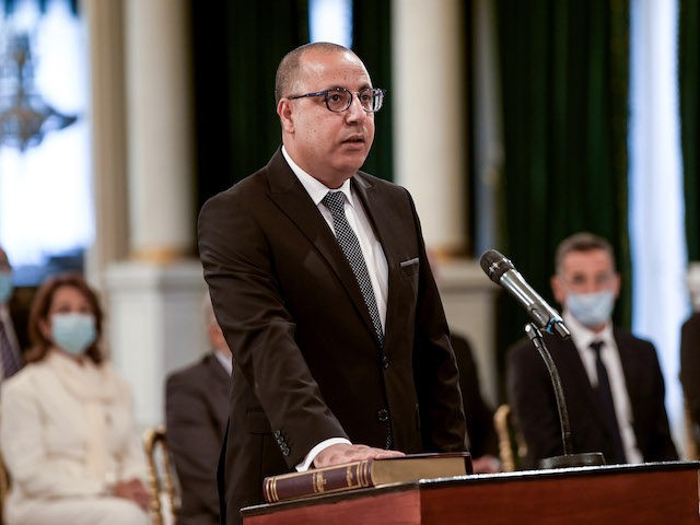 Tunisia's Prime Minister Hichem Mechichi takes the oath of office during the new government swearing-in ceremony at Carthage Palace on the eastern outskirts of the capital Tunis on September 2, 2020, following a confidence vote by parliament. - Tunisia's parliament has approved a new technocratic government tasked with tackling deep …