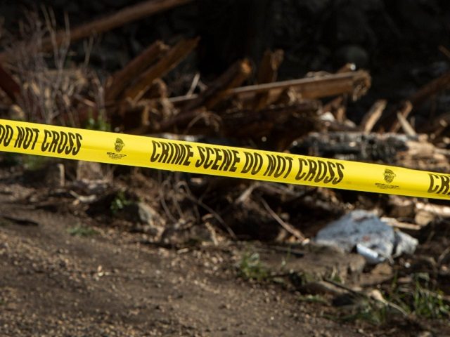 Crime scene tape blocks a pile of debris that crashed into a bridge along the Cache La Pou