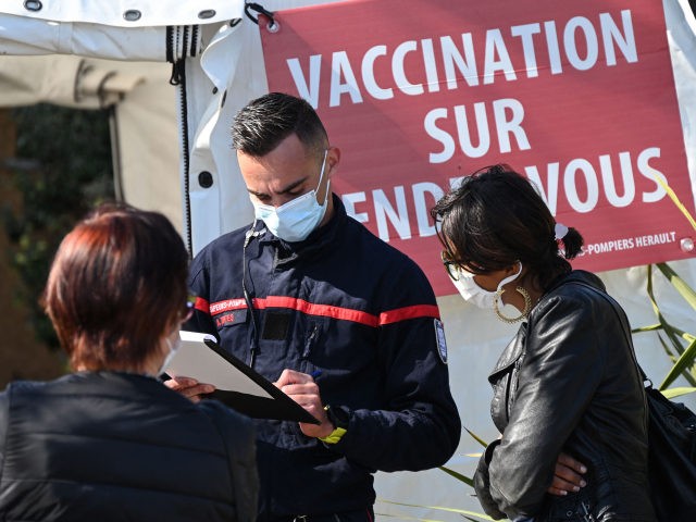 A firefighter checks his notes as he welcomes people to the SDIS34 fire station transformed into a temporary vaccination center, in Vailhauques near Montpellier in the south of France on April 8, 2021, during a vaccination campaign, aimed at curbing the spread of the pandemic of Covid-19. (Photo by Pascal …