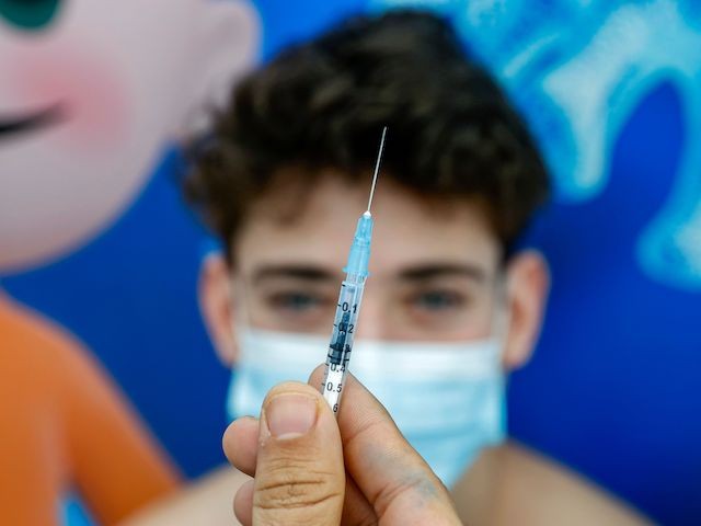 Michael, a 16-year-old teenager, receives a dose of the Pfizer-BioNtech COVID-19 coronavirus vaccine at Clalit Health Services, in Israel's Mediterranean coastal city of Tel Aviv on January 23, 2021. - Israel began administering novel coronavirus vaccines to teenagers as it pushed ahead with its inoculation drive, with a quarter of the population now vaccinated, health officials said. (Photo by JACK GUEZ / AFP) (Photo by JACK GUEZ/AFP via Getty Images)