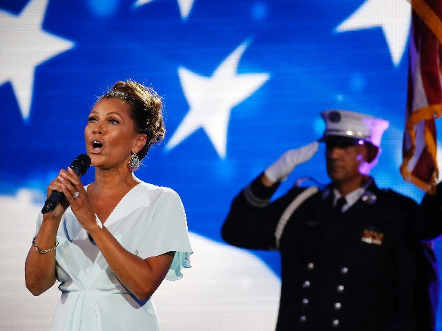 Vanessa Williams, left, sings the national anthem before the start of the first round of t