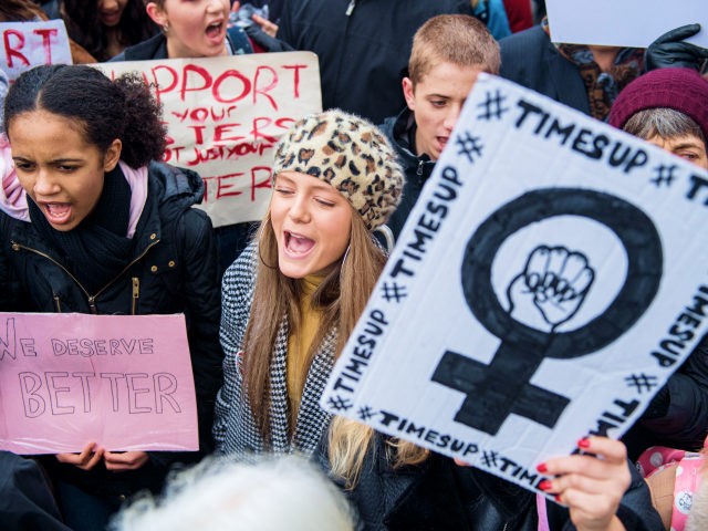 LONDON, ENGLAND - JANUARY 21: Women's rights demonstrators hold placards and shout slogans