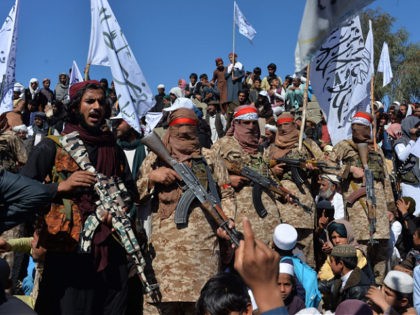 TOPSHOT - Afghan Taliban militants and villagers attend a gathering as they celebrate the peace deal and their victory in the Afghan conflict on US in Afghanistan, in Alingar district of Laghman Province on March 2, 2020. - The Taliban said on March 2 they were resuming offensive operations against …