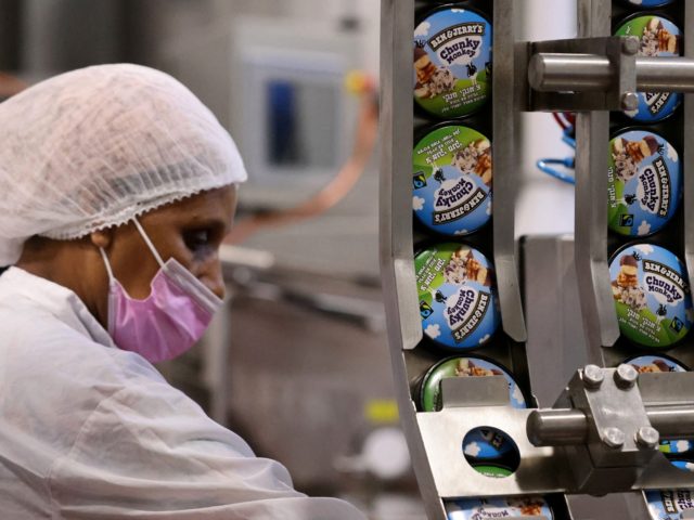 A labourer works on a production line filling ice-cream pots at the Ben & Jerry's factory in Be'er Tuvia in southern Israel, on July 21, 2021. - Ben & Jerry's announced that it will stop selling ice cream in the Israel-occupied Palestinian territories since it was "inconsistent with our values", …
