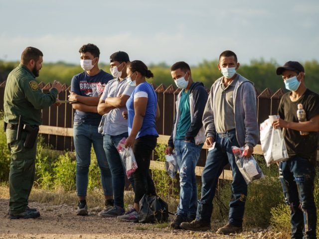 Migrants are processed by United States Border Patrol after crossing the US-Mexico border into the United States in Penitas, Texas on July 8, 2021. - Republican lawmakers have slammed Biden for reversing Trump programs, including his "remain in Mexico" policy, which had forced thousands of asylum seekers from Central America …