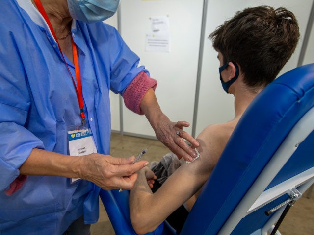Illustration picture shows a boy receiving a Johnson & Johnson vaccine at the COVID-19 vaccination center at Brussels Expo, on the Heysel-Heizel, in Brussels, Saturday 26 June 2021. From next Thursday, 1 July, all Brussels residents aged 16 or older can also register without an appointment at one of the …