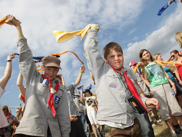 ALMKE, GERMANY - JULY 31: Youth scouts wave with their neckerchief at the camp on July 31,