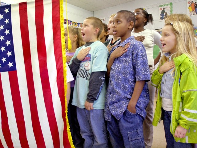 Third and fourth graders at Wanless Elementary School in Springfield, Ill., participated the President George Bush's request to recite the Pledge of Allegiance simultaneously across the country as show of national support Friday, Oct. 12, 2001. (AP Photo/Seth Perlman)