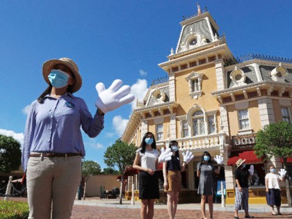 Employees wearing face masks to prevent the spread of the new coronavirus, welcome visitor