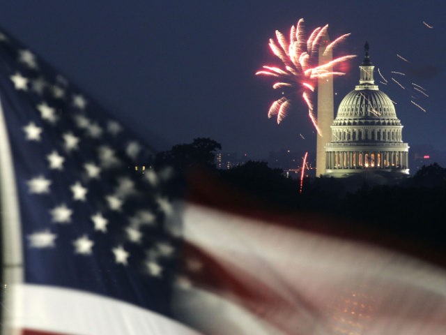 Fireworks explode in the sky above the Washington Monument and the U.S. Capitol, as a U.S.