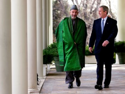 US President George W. Bush (R) walks with Interim Leader of Afghanistan Hamid Karzai as they leave the Oval Office 28 January 2002 to a joint press conference in the Rose Garden at the White House in Washington, DC. Bush announced the US would provide an additional 50 million USD …
