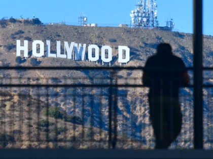 A man views the Hollywood sign from a walkway at a Hollywood shopping mall on October 16,