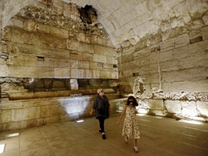 People walk inside a 2,000 year old luxurious banquet hall erected near the Temple Mt. during the Second Temple Period uncovered in the Western Wall tunnels on Thursday. Photo by Debbie Hill/UPI