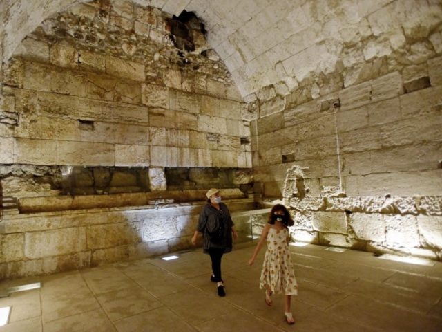 People walk inside a 2,000 year old luxurious banquet hall erected near the Temple Mt. during the Second Temple Period uncovered in the Western Wall tunnels on Thursday. Photo by Debbie Hill/UPI