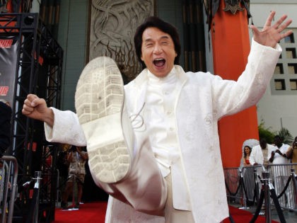 Jackie Chan cast member of the film "Rush Hour 3" throws a kick as he poses for photographers the premiere of the film at the Mann's Chinese Theater in the Hollywood section of Los Angeles, Monday July 30, 2007. (AP Photo/Kevork Djansezian)