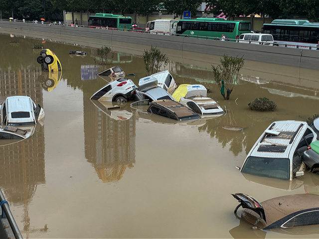 Cars sit in floodwaters after heavy rains hit the city of Zhengzhou in China's central Hen