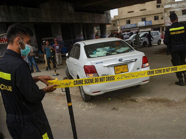 Security officials examine a vehicle that was carrying Chinese nationals in Pakistans port