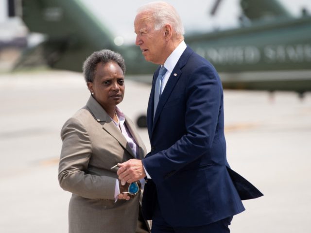 US President Joe Biden greets Chicago Mayor Lori Lightfoot (L) as he disembarks from Air Force One upon arrival at O'Hare International Airport in Chicago, Illinois, July 7, 2021, as he travels to promote his economic plans in Illinois. (Photo by SAUL LOEB / AFP) (Photo by SAUL LOEB/AFP via …
