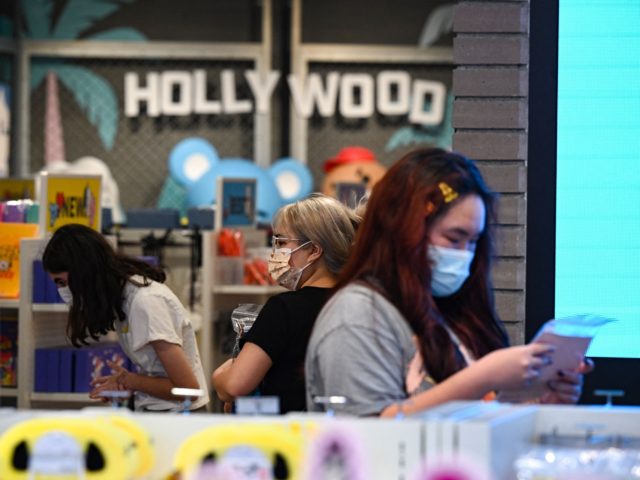 People shop at a store in Hollywood, California, on July 19, 2021, the second day of the return of the indoor mask mandate in Los Angeles County due to a spike in coronavirus cases. - The US surgeon general on July 18 defended a renewed mask mandate in Los Angeles, …