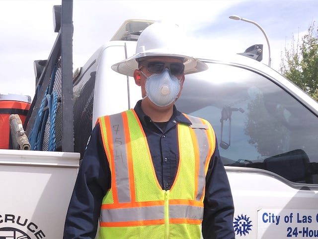 Las Cruces Utilities Water Line Maintenance associate Jaime Romero in full PPE ‚Äî mas