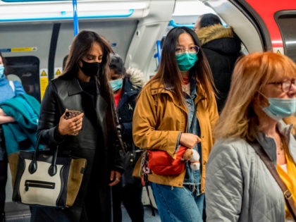 Commuters wear face-masks during morning rush hour on the Victoria Line of the London Unde