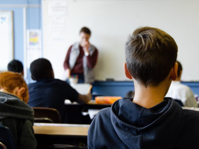 A Rhode Island white middle school teacher described how her school district’s “radica