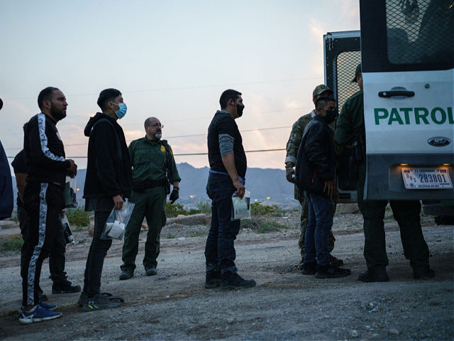 Migrants caught crossing the US-Mexico border are loaded into a transport van by US Border Patrol agents in Sunland Park, New Mexico on July 22, 2021. - Many advocates from national organizations urge President Biden to end Title 42 expulsions, a public health order issued in March 2020 by the …