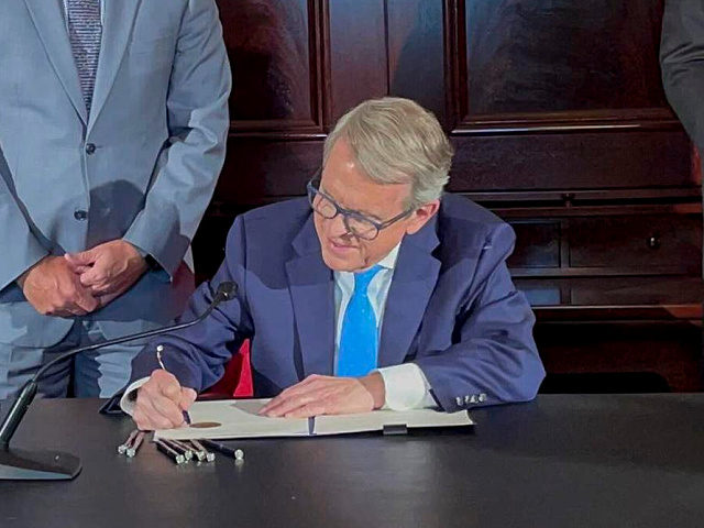Ohio Governor Mike DeWine signs an executive order allowing college athletes in Ohio to earn money off their name, image and likeness Monday, June 28, 2021, at the Ohio Statehouse in Columbus, Ohio. The order would bring Ohio up to speed with more than a dozen states who now prevent …