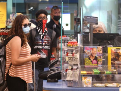People wear masks as they shop at a store in Union Station on July 30, 2021 in Washington, DC. DC Mayor Muriel Bowser restored a COVID-19 indoor mask mandate, regardless of vaccination status, starting Saturday. (Photo by Kevin Dietsch/Getty Images)
