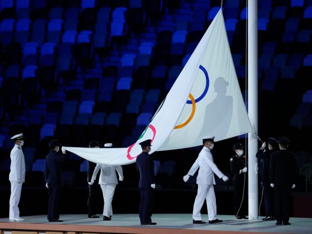 The Olympic flag is raised during the opening ceremony in the Olympic Stadium at the 2020 Summer Olympics, Friday, July 23, 2021, in Tokyo, Japan. (AP Photo/Ashley Landis)
