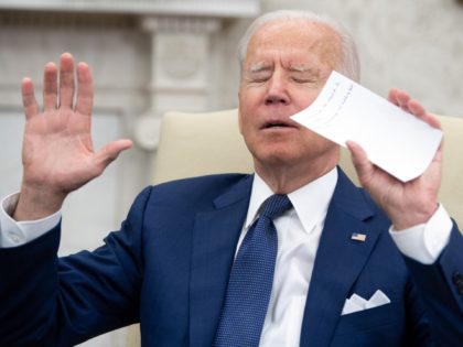 US President Joe Biden tries to get members of the media to stop shouting questions as he